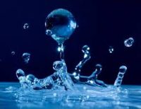 Image of a drop of water falling into a pool of water